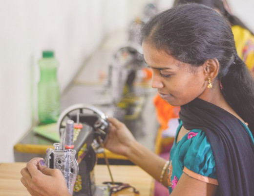 Woman with black sewing machine in India Punjammies