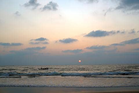 sun over ocean in Palavakkam Beach, India