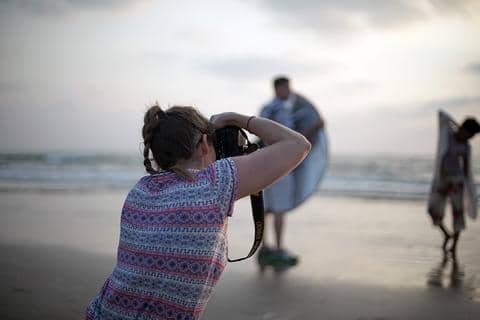 Photographer on shore in Palavakkam Beach, India