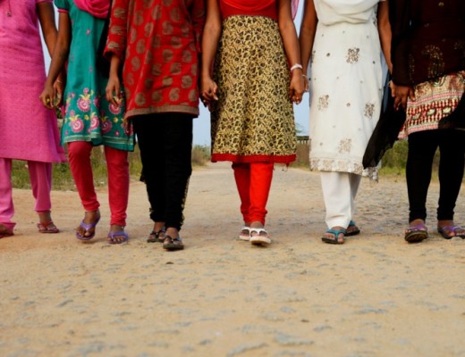 Indian women walking down a road