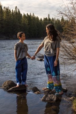 Shannon holding son's hand at the river